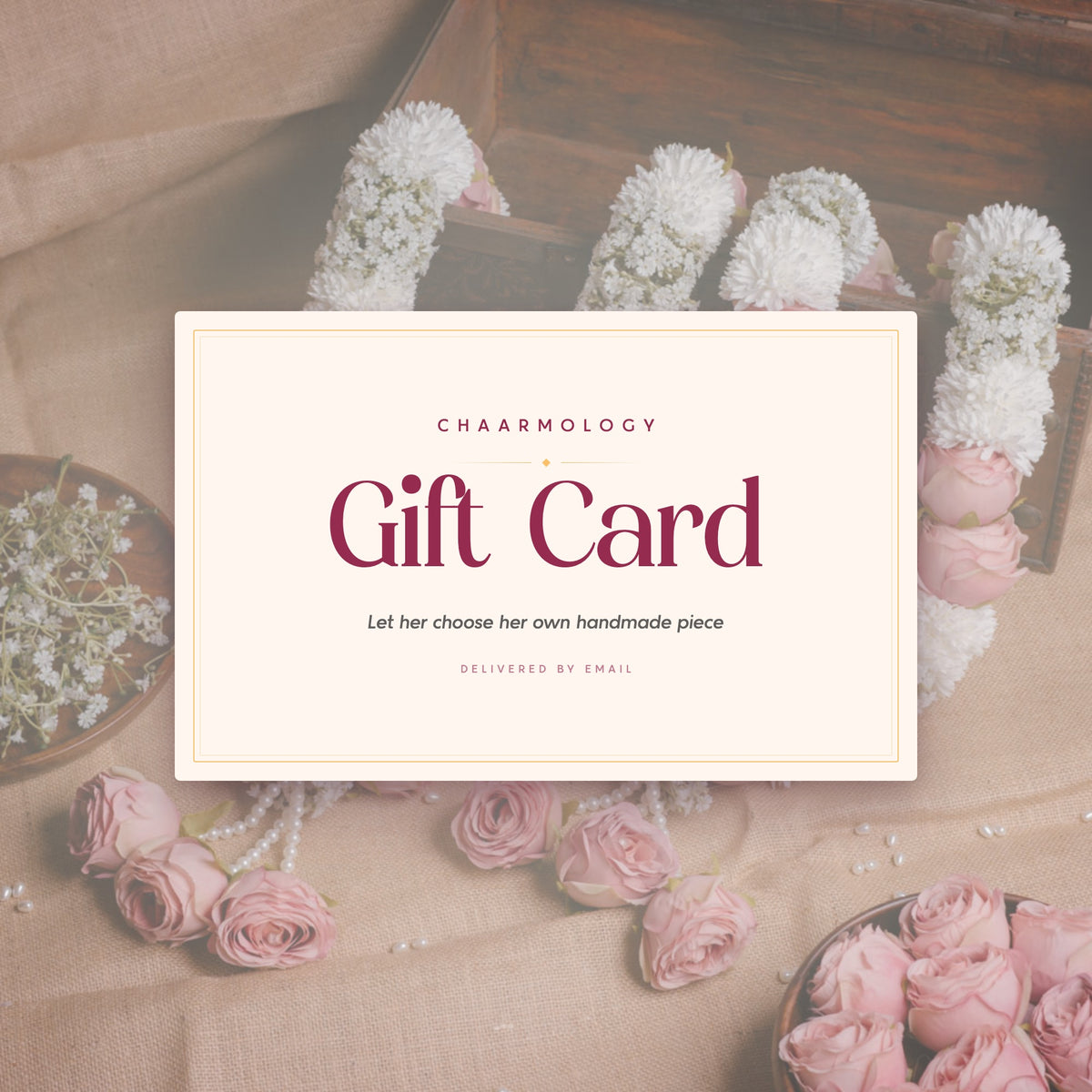 Chaarmology gift card resting among handmade floral jewellery