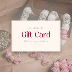 Chaarmology gift card resting among handmade floral jewellery